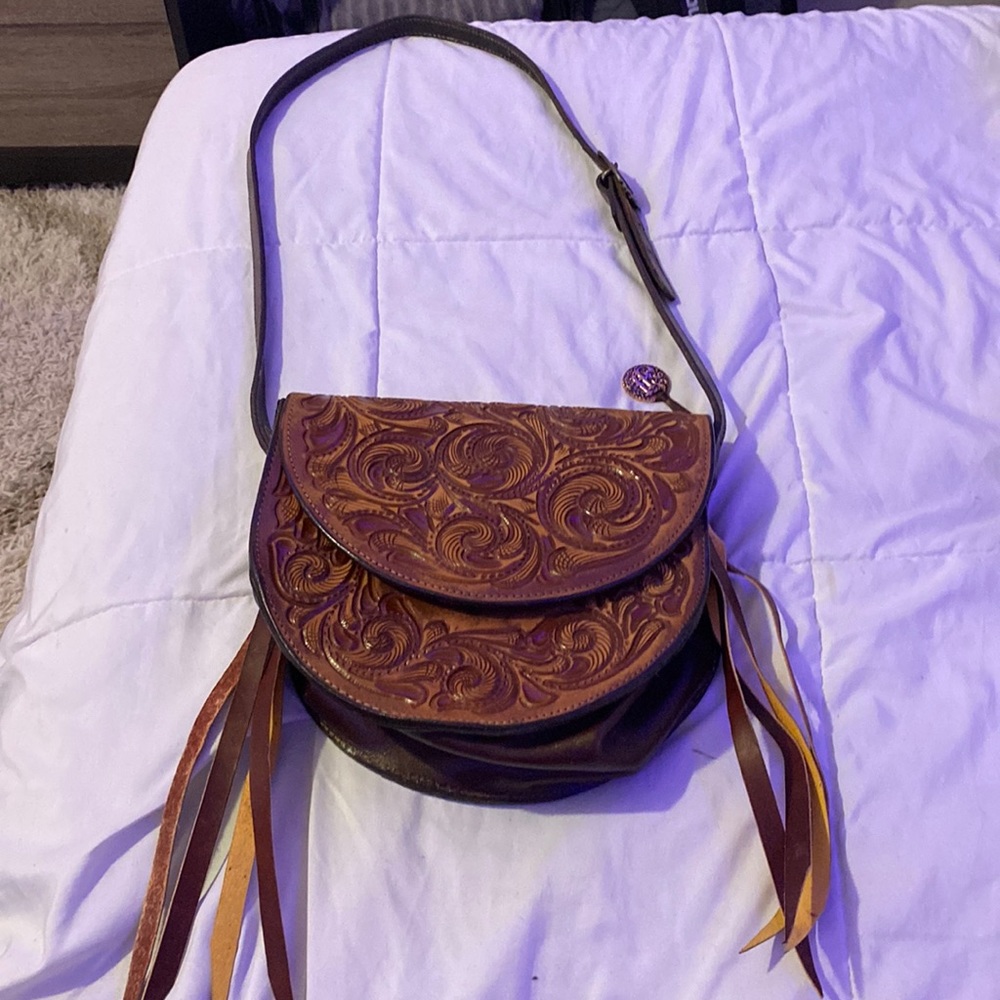 brown double j saddlery purse with leather tassels on the sides